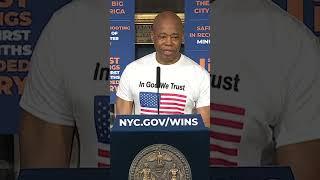 Eric Adams attends weekly press briefing wearing "In God We Trust" t-shirt