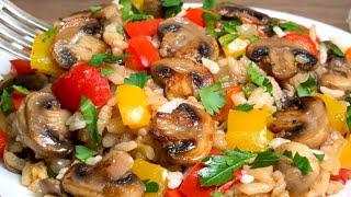 Rice with vegetables and mushrooms in a frying pan. Simple and incredibly tasty!