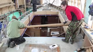 Laminating curved roof beams and bedding the cabsides. Episode 16