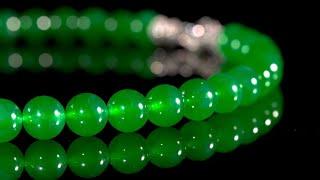 An Extraordinary 'Imperial Green' Jadeite Bead and Diamond Necklace