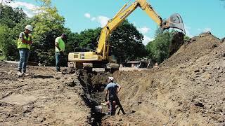 Komatsu PC450 Excavator Digging Storm Drain