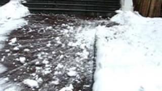 Throwing a huge snowball off the roof.