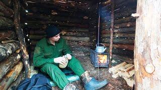 Building a warm winter shelter in the forest, survival skills