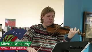 Michael Westerby, a high school violinist gives a Christmas concert at G.I. Public Library Monday