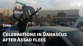 Syrians and fighters celebrate in Damascus | AFP