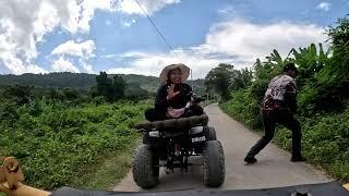 Quad biking through rugged terrain to beautiful waterfall Langkawi Malaysia