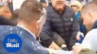 Tommy Robinson swings at protestor after being hit with milkshake