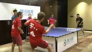 Lahm and Muller playing with ping pong world champions