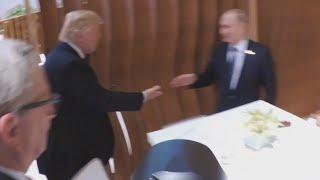 Trump and Putin's historic handshake and 'backslap'