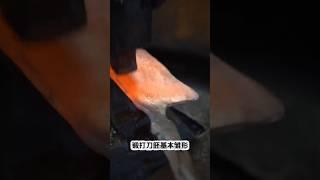 A blacksmith forges a sharp cutting knife