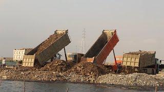 Extremely Dump Truck unloading Gravel Rock, with  Biggest Bulldozer & Wheel loader pushing in  water