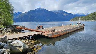 Tugboat built in 1944 the Sea Champ pushing a 120' foot barge out of Toba Inlet.   Empty tankers.