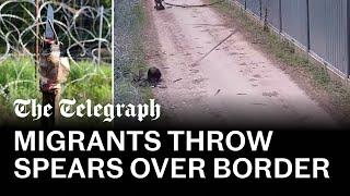 Migrants throw makeshift spears at Polish border guards