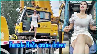 A day of lifting goods on the street. Beautiful female crane driver HEZE