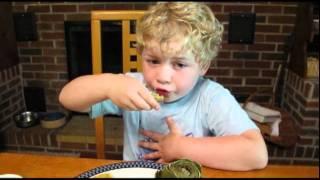 A five-year-old demos how to eat an artichoke