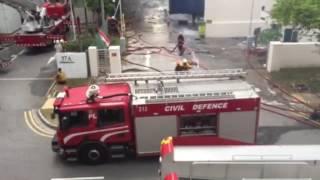 SCDF spraying jets of water at the C K Building fire