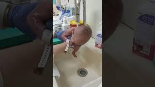 My newborn baby boy takes his first shower