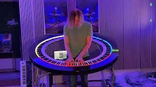 Brockett Parsons improvises some dark, ambient, jazzy chords on his circular keyboard.