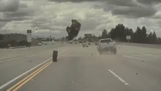 A Kia Soul, launched on a highway by a fallen wheel from a Chevy