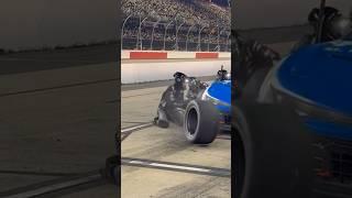 Smooth behind the back move with the jack during NASCAR pit stop.