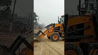 JCB working leveling mud