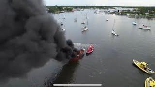 MCSO Sheriff rescuing a guy off a vessel fire, and Towboat US towing it to the fire dept 8/14/2022