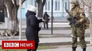 Ukrainian woman confronts armed Russian soldier - BBC News