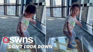 Hilarious moment a Japanese toddler reacts to a glass floor viewing platform of Tokyo streets | SWNS