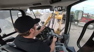 Caterpillar 908M Being put to Work Loading Trucks - Cab POV