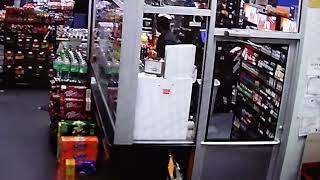 DRAMATIC VIDEO: Safety glass protects clerk when armed robber opens fire