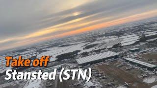 Snowy sunset during take off in Stansted Airport (STD) with Ryanair