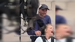 The King's Guard guides his horse closer to a special tourist