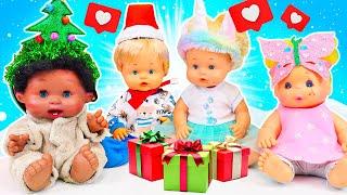 Baby dolls decorate the Christmas tree with beautiful toys and ornaments. Christmas videos for kids.