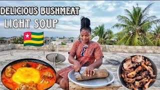 African village cooking. Delicious bushmeat light soup and yam fufu.