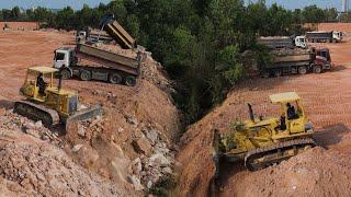 The Best Big Project Equipment Bulldozer Pushing Big Rock Stone and Clear Forestry with Dump Truck