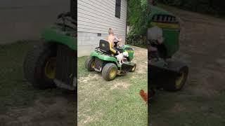 Gage and his 3 year old Poo-Chon, Gus riding on the lawn mower.