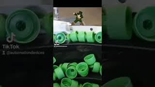 Automation Devices vibratory feeding system orienting green parts for St. Patrick's Day