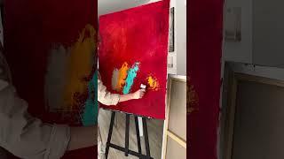 Flavia Birsan creating a textured red painting