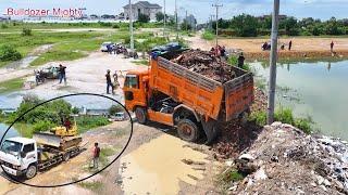 Full Processing Filling Up The Land huge, By Bulldozer KOMATSU D37P And Dump Truck Unloading