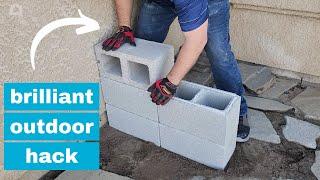 He stacks cinder blocks in his front yard for a brilliant outdoor furniture idea!