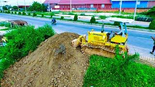 Amazing bulldozer skill pushing soil filling land with dump trucks