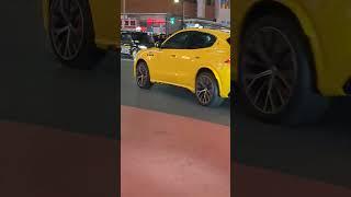 A Yellow Nice Car passing through Shibuya. Tokyo, Japan.