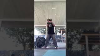 15 Dumbbell Swings with 50 lb. Dumbbells