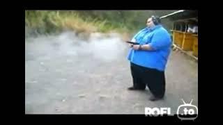 fat guy shooting a gun