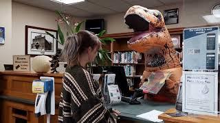 T-Rex Tricia works at the checkout desk!