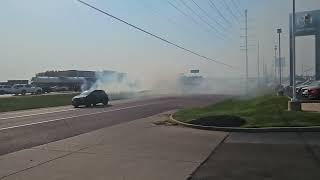 A grass fire breaks out in front of the dealership!