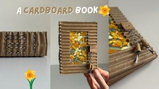 a handmade book made out of cardboard  bookbinding with quiet music