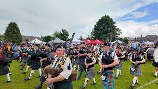 Drum Majors lead the massed pipe bands final march during 2024 Dufftown Highland Games in Scotland