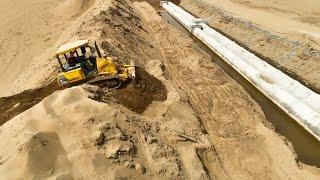 Great Activity Small Bulldozer Clearing Sand Fill On The Drains On a Big Land