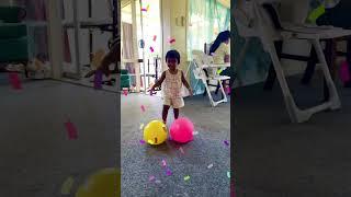 Baby girl lifting 2 balls together. Cute motivational video. Never give up